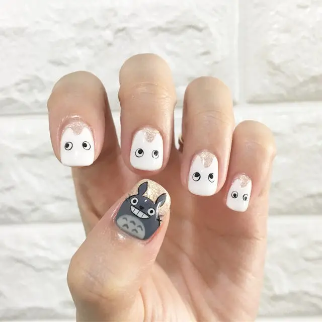 Fun and quirky nails with eye and face art — personality at your fingertips.